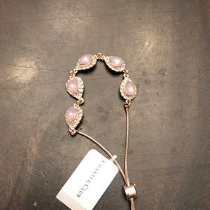 Gold tone bracelet with pink stones